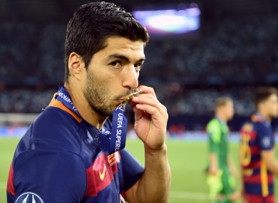 Barcelona's Luis Suarez poses kisses his medal after winning the UEFA Super Cup.