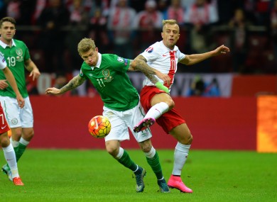 Ireland's James McClean tackles Poland's Kamil Grosicki.