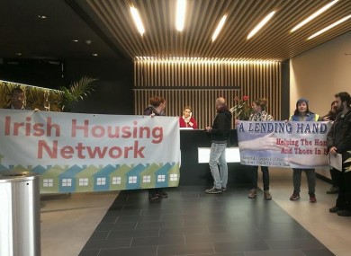 Activists display banners in the reception area of Blackstone's Dublin offices