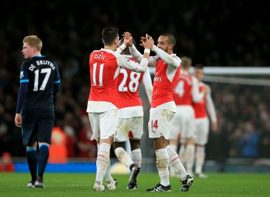 Arsenal's Theo Walcott (right) celebrates scoring their first goal of the game with team-mate Mesut Ozil (centre left).