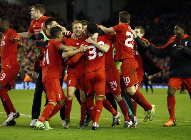 Liverpool's players celebrate after winning the English League Cup semi-final second leg.