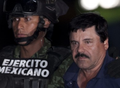 Guzman is escorted by soldiers and marines to a waiting helicopter.