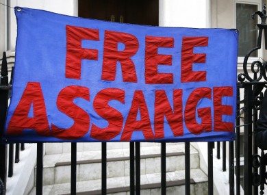 A demonstrator holds a banner outside the Ecuadorean Embassy in London.