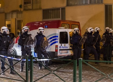 Police officers secure a street during a raid in the Molenbeek neighborhood of Brussels on Friday 18 March.