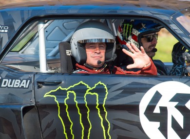 Actor and Top Gear presenter Matt LeBlanc, left, waves , as he sits with rally driver Ken Block during filming of BBC Top Gear in Westminster, London on Sunday