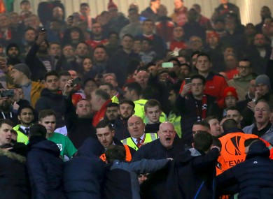 Steward try to calm the situation between rival fans last night.