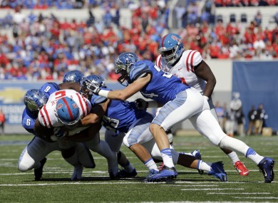 Mississippi defensive tackle Robert Nkemdiche (5) is brought down by Memphis defenders as Nkemdiche runs the ball on an offensive play in the first half of an NCAA college football game last year. He suffered a concussion on the play.