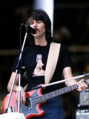 Eagles bassist Randy Meisner performing on stage, circa 1975.