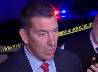 A police spokesman speaks to reporters in the aftermath of the shooting.