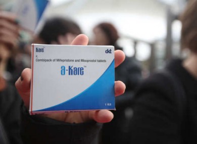 A pro-choice protester holds a box of abortion pills at Connolly Station after bringing them to Dublin from Belfast in October 2014.