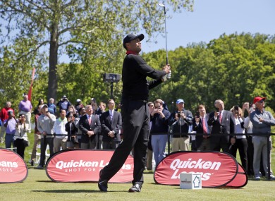 Tiger Woods watches the first of three ceremonial balls from the 10th tee during a Quicken Loans National golf tournament media availability at Congressional Country Club.