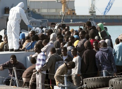 Migrants waiting to disembark from an Italian Finance Police vessel in April 2015