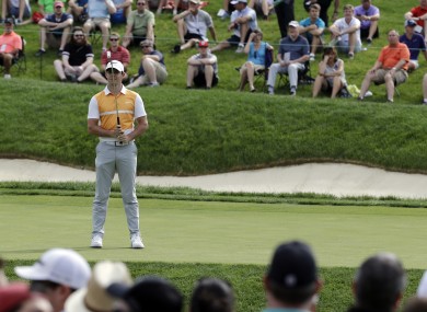 Rory McIlroy reacts after missing a putt on the 14th hole during the first round of the Memorial golf tournament.