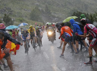 Martin, far left, and the rest of the peloton had to battle testing weather on Sunday.