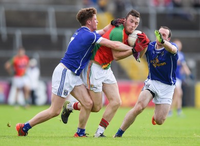 Carlow's Darragh Foley with Ciarán Brady and Feargal Flanagan of Cavan.