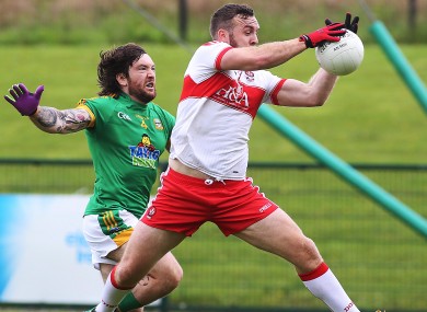 Emmett McGuckin gets out in front of Meath's Mickey Burke to win possession.