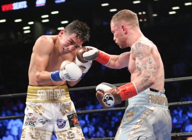 Carl Frampton, right, lands a punch on Leo Santa Cruz during their WBA Super World Featherweight Championship fight at the Barclays Center in the Brooklyn borough of New York on Saturday.