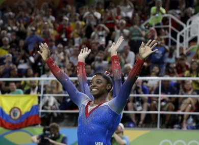 United States' Simone Biles greets the crowd after winning gold for floor during the artistic gymnastics women's apparatus final.