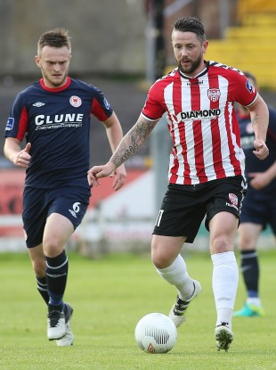 Derry goalscorer Rory Patterson with David Cawley of St Pat's.