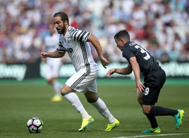 Juventus' Gonzalo Higuain (left) and West Ham United's Josh Cullen battle for the ball.