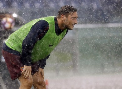 Francesco Totti looks on in the rain before being introduced as a substitute against Sampdoria.