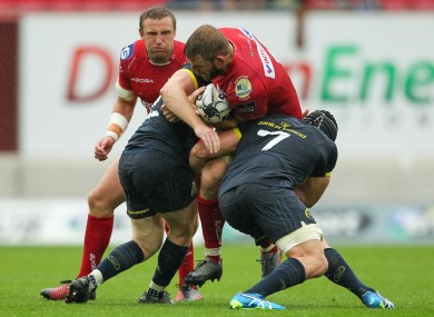 Munster's Niall Scannell and Tommy O'Donnell tackle John Barclay during last weekend's game against Scarlets.