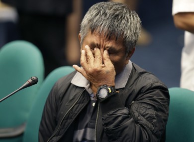 Former Filipino militiaman Edgar Matobato pinches his nose during a break of testimony at the Philippine Senate today.