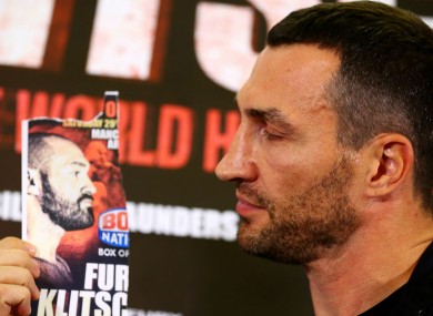 Wladimir Klitschko poses with an image of Tyson Fury, who failed to turn up for a media conference.