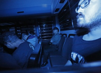Rurik Jutting, right, a British banker, sitting in a prison bus, leaves a court in Hong Kong in 2015 (File photo)