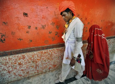 An under-age newly-married couple who refused to be identified walk together after a mass marriage at Chachoda village in Rajgarh town, India. Even though child marriages are illegal in India, they are still held particularly in small poverty stricken villages.