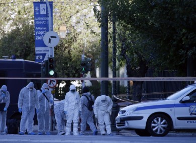 Police search for evidence after an explosion outside the French Embassy in Athens.