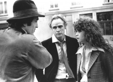 Director Bernardo Bertolucci, left, discusses a scene from