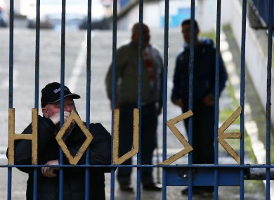 People standing behind the gates of Apollo House last month.