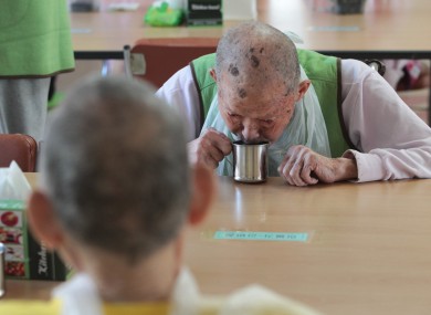 A man with leprosy drinks water at a specialist hospital in South Korea.