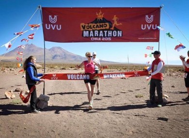 Kane crossing the finish line at the Volcano Marathon in 2015.