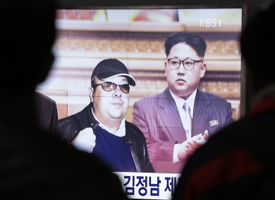 A TV screen shows pictures of North Korean leader Kim Jong Un (R) and his older brother Kim Jong Nam (L).