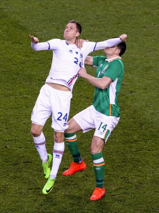 Iceland striker Kjartan Henry Finnbogason catches Egan with his arm.