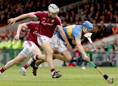 Galway's Daithi Burke and Tipperary's John McGrath battle for possession.