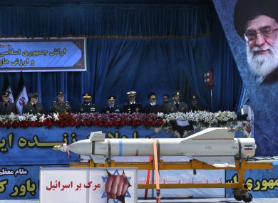 A missile is displayed on a truck with an anti-Israeli banner which reads in Persian