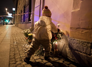 A child lays flowers near metro station where bomb exploded.