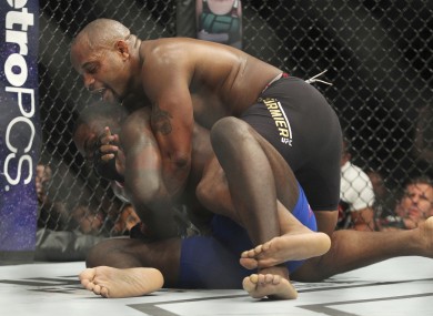 Daniel Cormier, top, battles Anthony Johnson during a light heavyweight mixed martial arts bout at UFC 210.