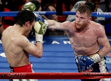 Canelo Alvarez, right, of Mexico, hits Julio Cesar Chavez Jr.