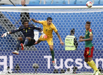 Cameroon goalkeeper Fabrice Ondoa, Australia's Tim Cahill and Cameroon's Adolphe Teikeu in action.