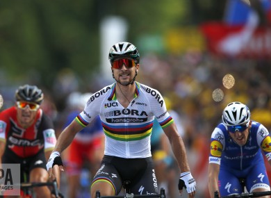 Peter Sagan of Slovakia,, crosses the finish line ahead of Ireland's Daniel Martin, right, and Belgium's Greg van Avermaet.