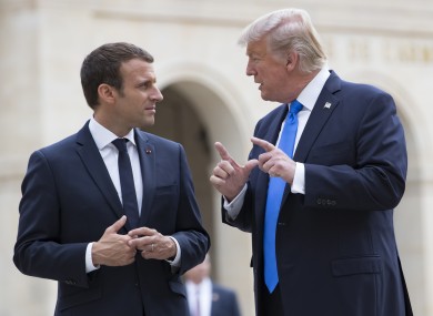 French President Emmanuel Macron listens to Trump while leaving Les Invalides museum in Paris.