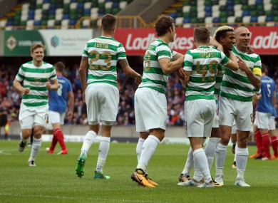 The Celtic players celebrate Sinclair's goal.