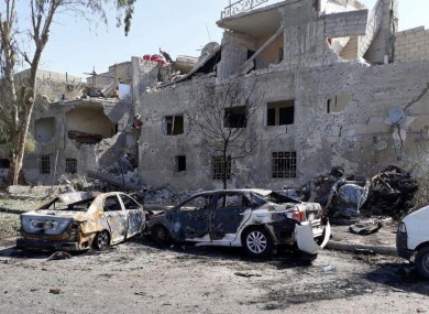 A photo released by the Syrian official news agency SANA shows several damaged cars along the road to the airport in southeast Damascus, Syria, today