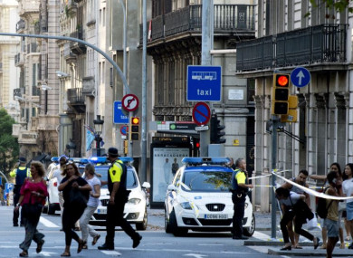 Police officers asking people to leave Plaza Catalonia following the nearby attack