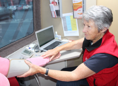 Nurse Carol Pye testing a patient's blood pressure in the Irish Heart Foundation's mobile health unit
