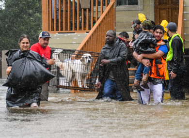 Volunteers and First Responders help flood victims evacuate to shelters in Houston, Texas.